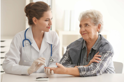 Doctor with stethoscope pricking the finger of adult adult female patient. 