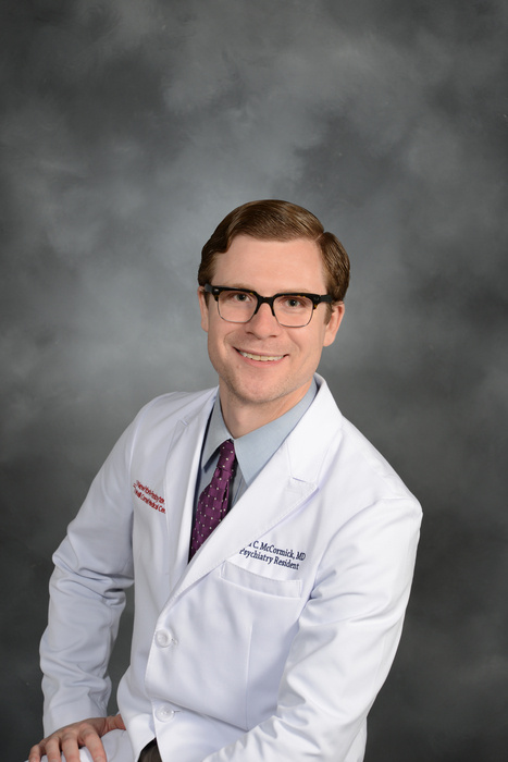 Professional headshot of Dr. McCormick. Her is wearing his white coat with a blue shirt and necktie. Dr. McCormick is wearing glasses and smiling at the camera.